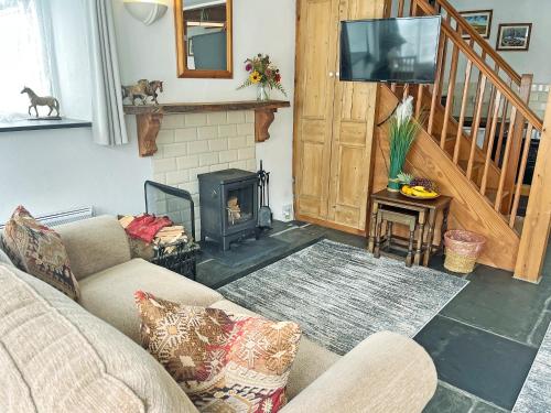 a living room with a couch and a fireplace at Mole Cottage - Uk52139 in Liskeard