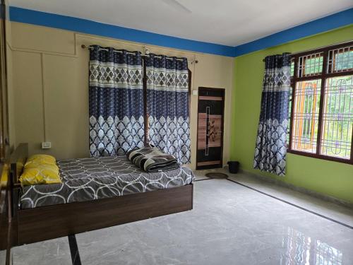 a bedroom with a bed in the corner of a room at Sharma Residency in Dithur