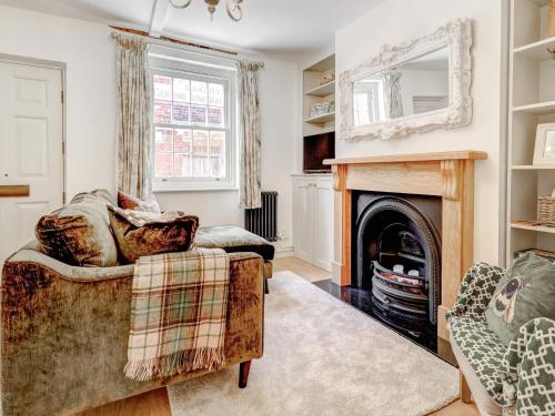 a living room with a couch and a fireplace at Bakers View in Winchester