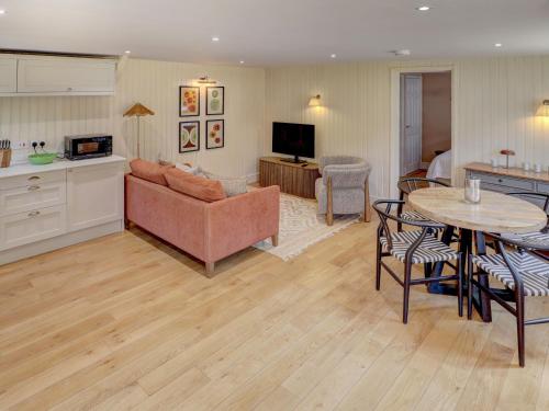 a living room with a couch and a table at Meadow Barn in Pulborough