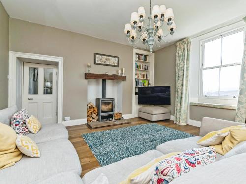 a living room with a couch and a fireplace at Low Seal House in Richmond