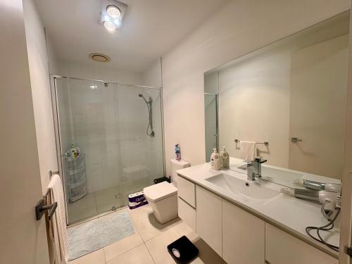 a bathroom with a shower and a sink and a toilet at Spacious Master Room with Private Ensuite in Melbourne