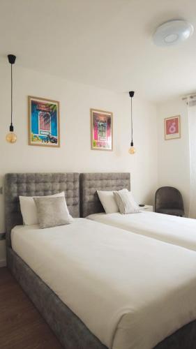 two large beds in a bedroom with two chairs at Caia House in Ourondo