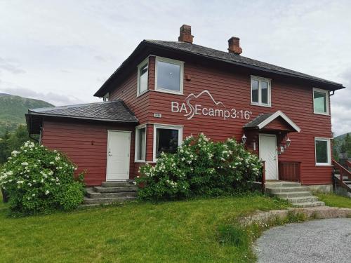 a red house with a sign on the side of it at Hemsedal - 7 bedrooms - WI-FI in Hemsedal