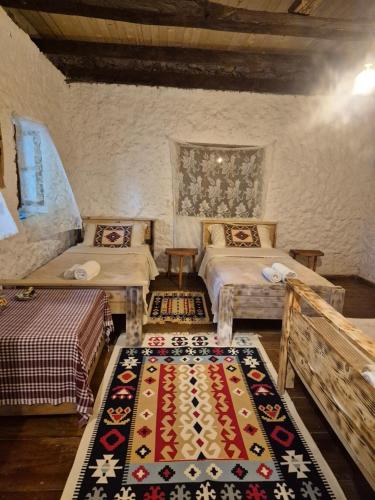 a room with two beds and a rug on the floor at Norral shelter 1 in Kajvall