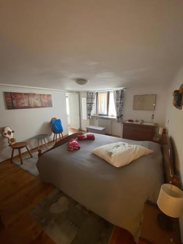 a bedroom with a large bed in a room at A Casa di Zia Renny in Châtillon