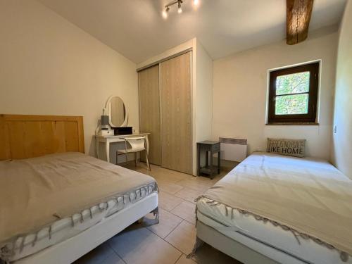a bedroom with a bed and a desk and a window at Mas Ferrieres Saint Laurent in Saint-Laurent-le-Minier