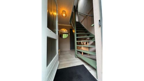 a hallway with a staircase leading to a closet at Huisje 47 | 8 persons in Gasselte