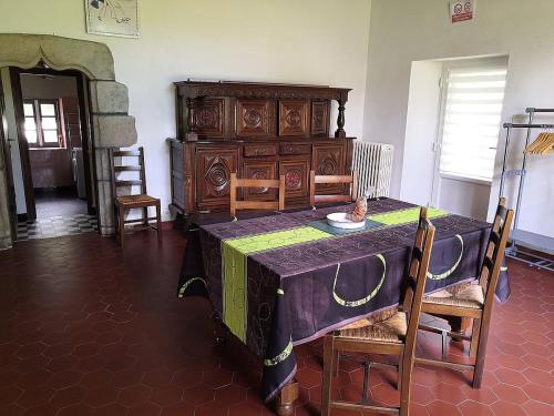 a room with a table and a wooden dresser at Ti Bleunv-nevez in Moëlan-sur-Mer