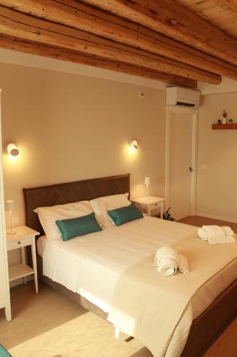 a bedroom with a large white bed with two tables at Cà Dei Nonni in Castelfranco Veneto
