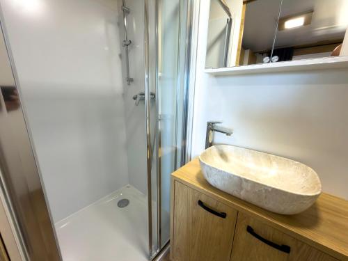 a bathroom with a sink and a shower at Mobile homes Camp Kozica in Sibinj Krmpotski
