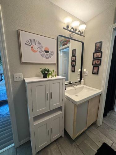 a bathroom with a sink and a mirror at Peace in the Holler in Eureka Springs