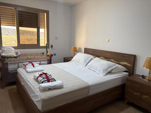 a bedroom with a large bed with towels on it at Marinamer 1 in Saïdia