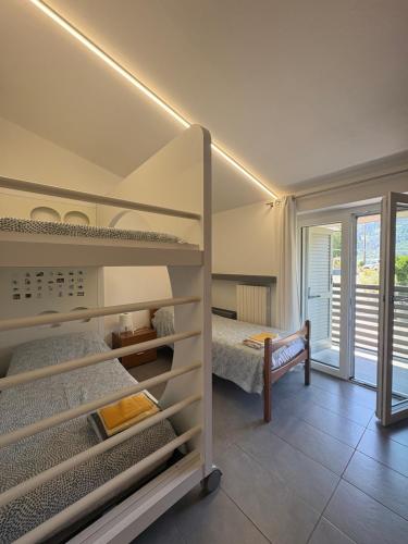 a bedroom with bunk beds and a bed and a window at Clusone - Dosso Cascì in Clusone