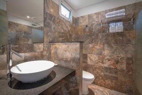 a bathroom with a sink and a toilet at Temple Beach Resort in Danang