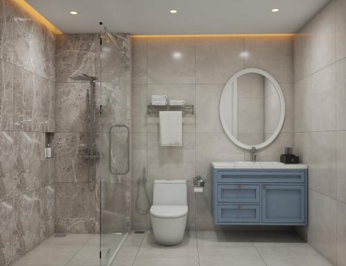 a bathroom with a toilet and a sink and a mirror at TTC Lotus Hotel in Phú Quốc