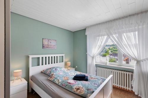 a bedroom with a bed and a window at Landidylle – Nostalgie in Ortenberg