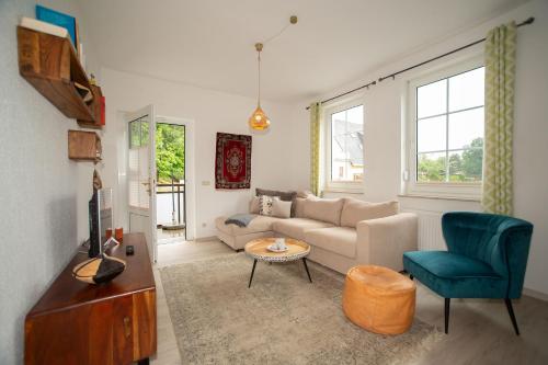 a living room with a couch and a chair at Zum Notar in Brand-Erbisdorf