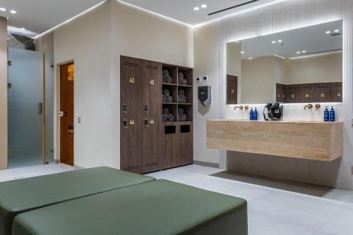 a bathroom with a vanity and a sink and a counter at Radisson Blu Hotel, Tashkent in Tashkent