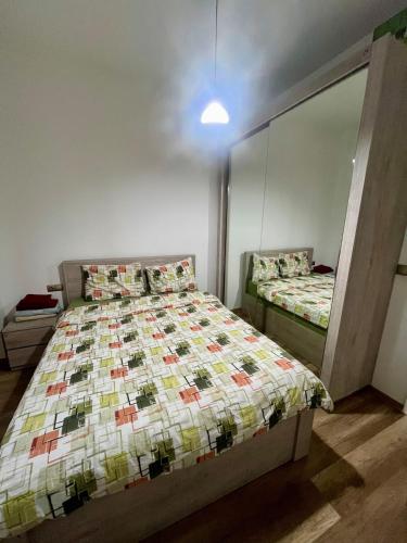 a bedroom with a bed and a mirror at Apartment in green Budapest in Tbilisi City