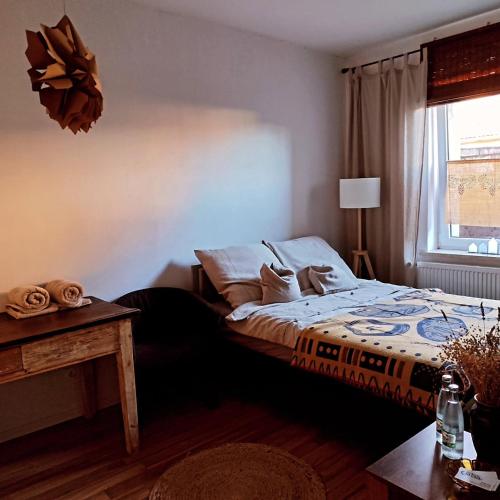 a bedroom with a bed and a window at Nie Samym Chlebem in Poborszów