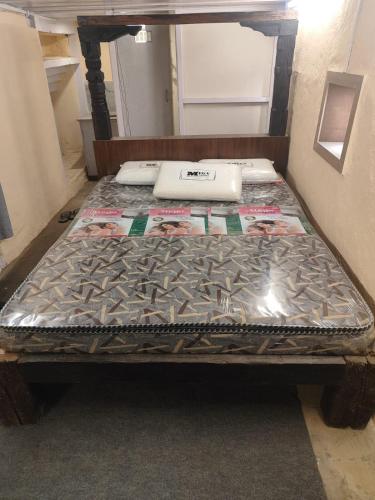 an empty bed in a room with a mattressvisor at Sanjhyā Durbar Homestay in Bhaktapur