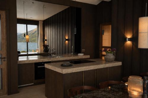 a kitchen with a sink and a counter top at Fredvang Lodge, Lofoten in Fredvang