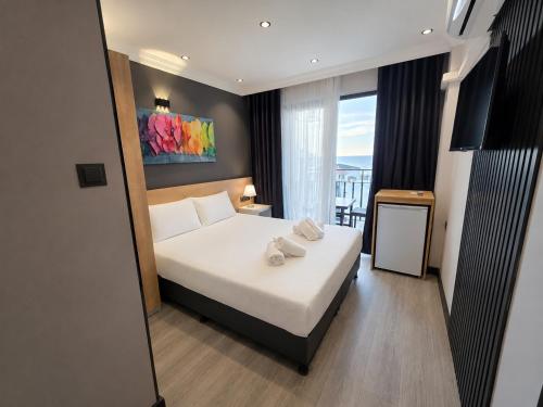 a bedroom with a bed with two towels on it at Ada Park Hotel in Kuşadası