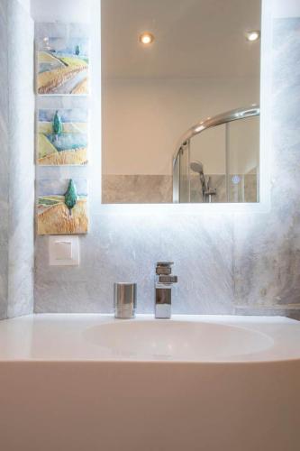 a bathroom with a sink with a mirror and a sink at Syntagma Gem 1 in Athens