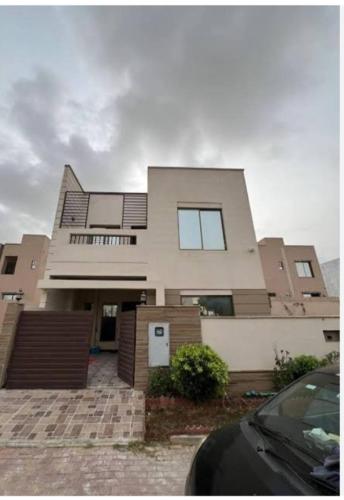 a large house with a car parked in front of it at House in Lahore