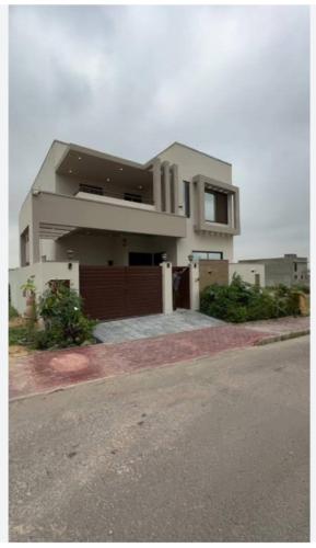 a large house with a driveway and a garage at House in Lahore