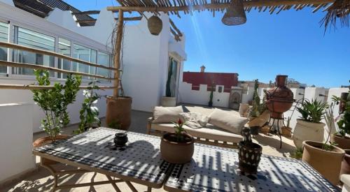 a patio with a couch and a table at Riad D’AR GANne by Carole in Essaouira