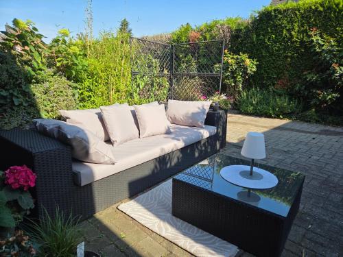 a couch sitting on a patio with a table at Kühles Souterrain Apartment mit privater Sauna und Terrasse in Duisburg