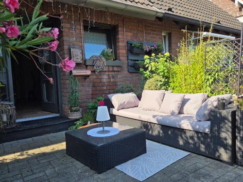 a couch sitting on a patio in front of a building at Kühles Souterrain Apartment mit privater Sauna und Terrasse in Duisburg