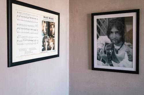 two framed photographs of a man on a wall at Surfers Lodge Peniche in Peniche