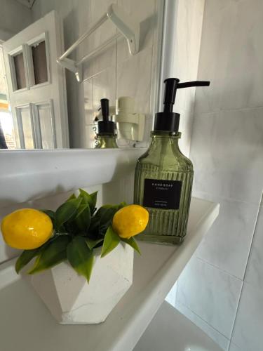 a bottle of soap and lemons on a shelf in a bathroom at Cleo Hotel in Alanya