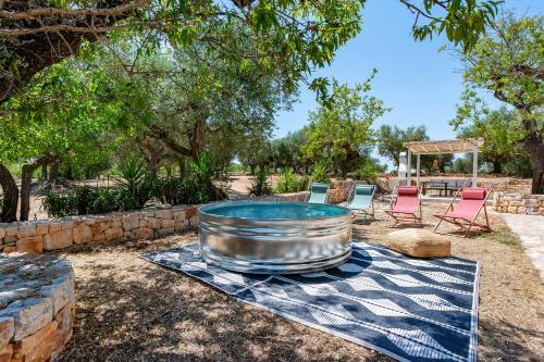 a large metal tub sitting on top of a blanket at Lamia Terra 3BR, Terrace & BBQ - Happy Rentals in Castellana Grotte