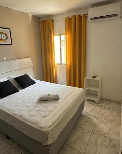 a bedroom with a large bed and a window at Hotel Lisboa II in São José dos Campos