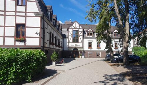 a building with a car parked in front of it at Grand Park Hotel in Szczecin