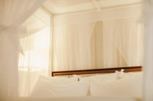 a bedroom with a bed with white pillows at Mà C'a - Casa Privata in Praiano