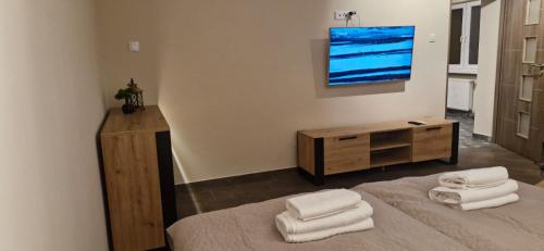 a bedroom with a bed and a dresser with towels at Breakpoint Loft - City Center in Łobez