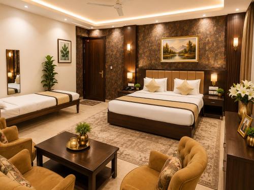a hotel room with two beds and a living room at Akshay Hotel in Gurgaon