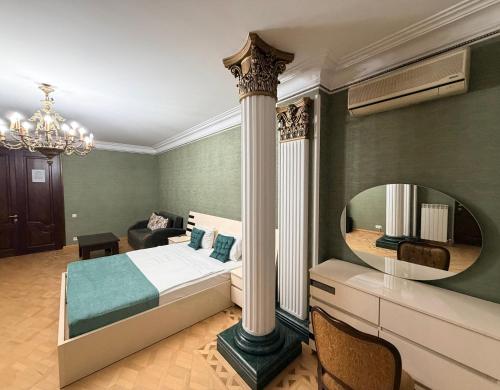a bedroom with a bed and a large mirror at Hotel All Time in Tbilisi City
