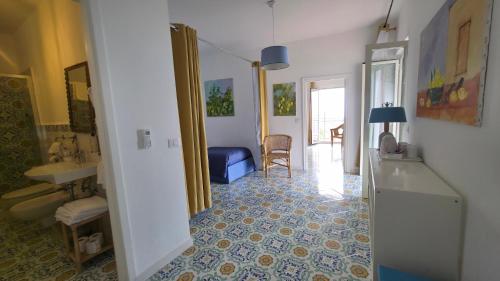 a hallway with a bathroom with a sink and a room at Agriturismo Fattoria Terranova in SantʼAgata sui Due Golfi