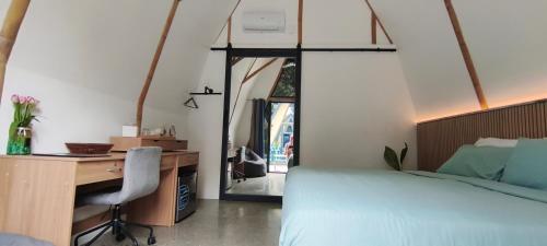 a bedroom with a desk and a bed and a desk and chair at Lokal Hotels Dauin in Dauin