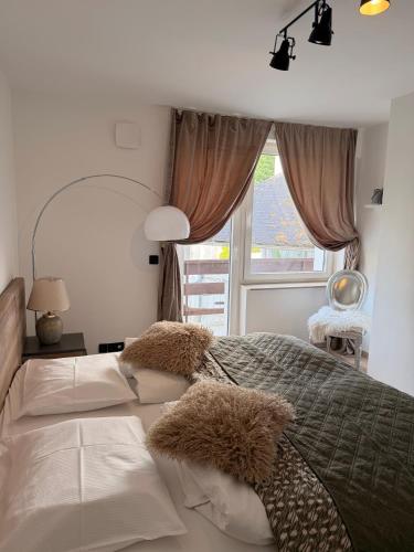 a bedroom with two white beds and a window at MM Rooms in Bled