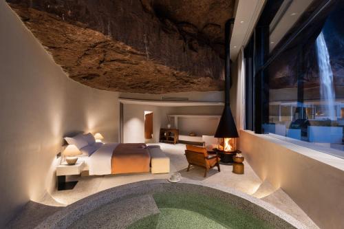 a bedroom with a bed and a large window at Enjoy nature Be energetic in Yunji