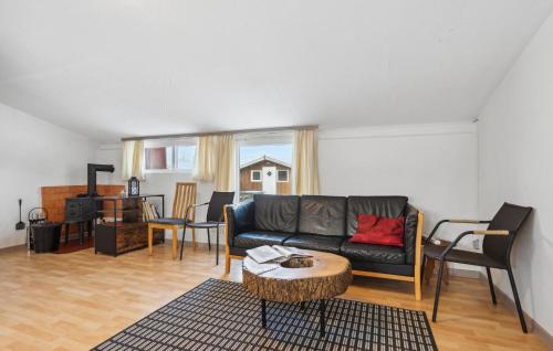 a living room with a couch and a table at 2 Bedroom Nice Apartment In Ringkøbing in Ringkøbing