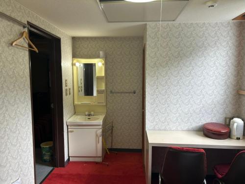 a bathroom with a sink and a mirror at RB hotel in Aizuwakamatsu