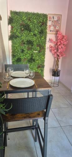 a table with plates and wine glasses on it at L'Esprit Zen #air conditioning #spa in Nercillac